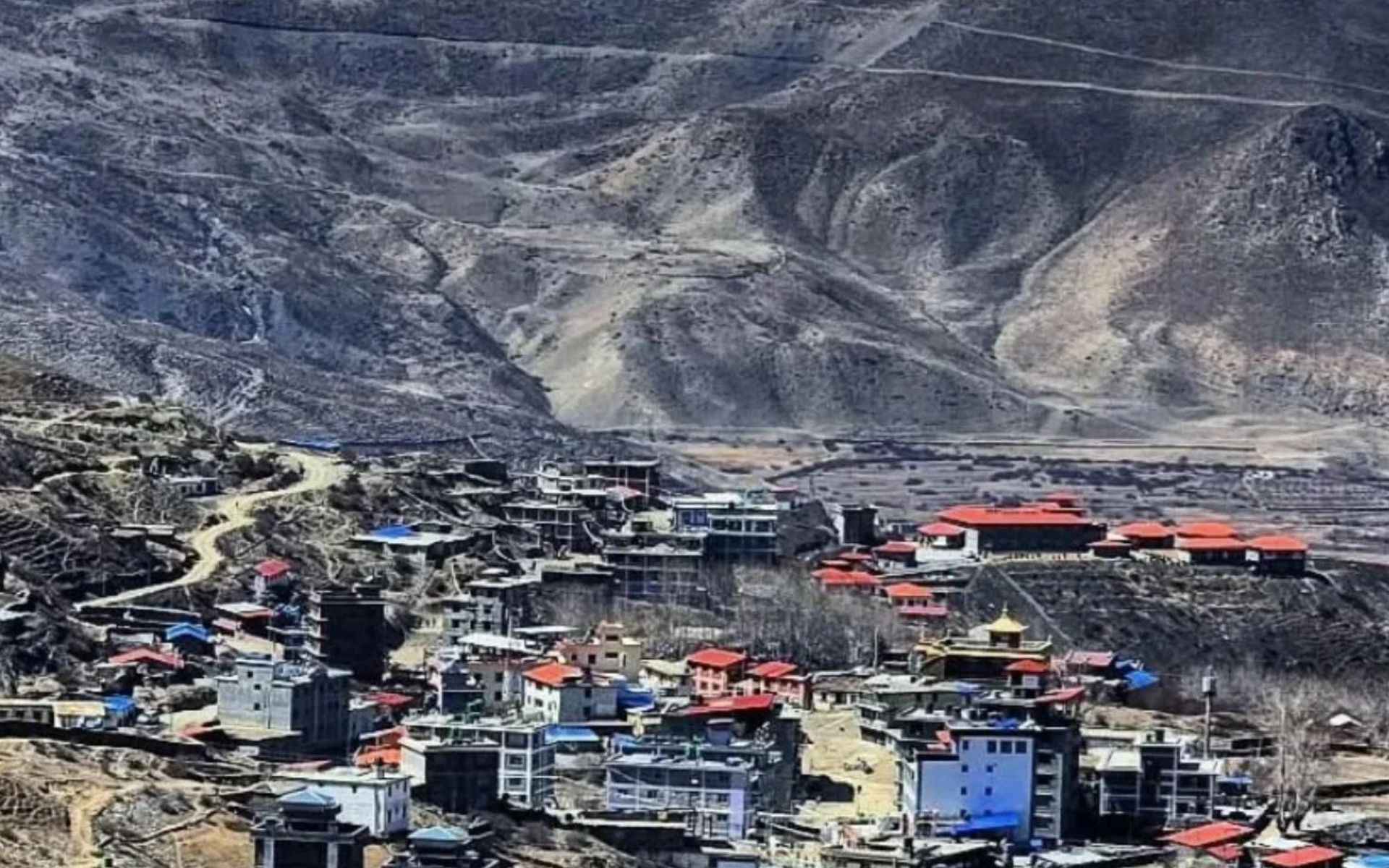 Settlement of Muktinath (Ranipauwa) in the Mustang district of Nepal, nestled against an arid mountain slope