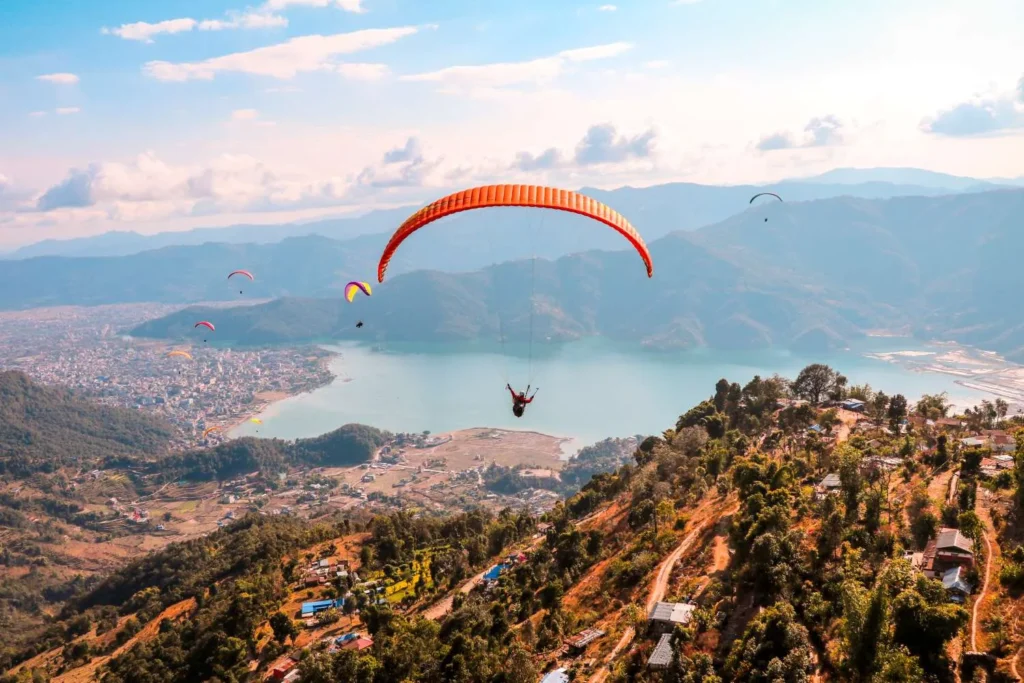 Group of paragliders flying over Phewa Lake Pokhara